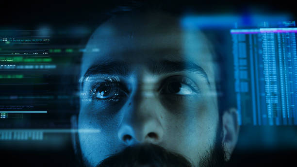 istock A close up of a young man eye controlling a futuristic computer system. Computer programmer coding on futuristic holographic display. 1195868234