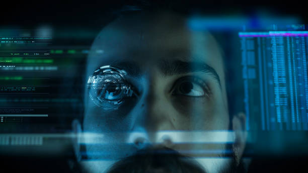 istock A close up of a young man eye controlling a futuristic computer system. Computer programmer coding on futuristic holographic display. 1195868293
