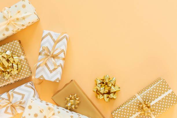 istock Holiday background with gold gift boxes 1195870740