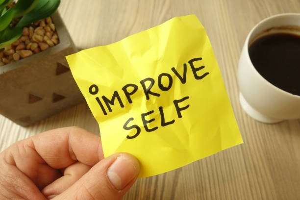 istock Improve self - motivational reminder handwritten on sticky note 1195872433