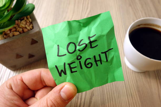 istock Lose weight - motivational reminder handwritten on sticky note 1195873685