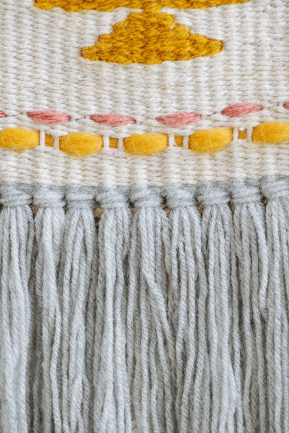istock Tight-weaved macrame banner from close distance with treads sewn in a pattern. 1195874369