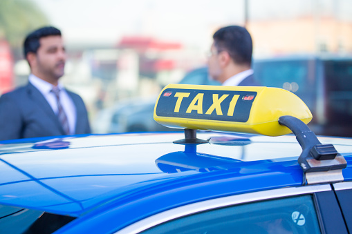 Blue taxi with business persons
