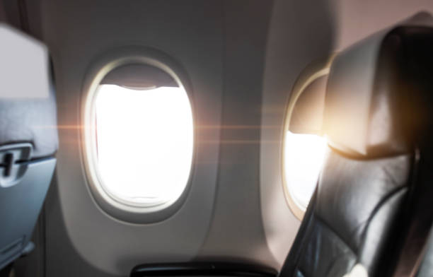 istock Empty aircraft seats and windows with sun light 1195875977