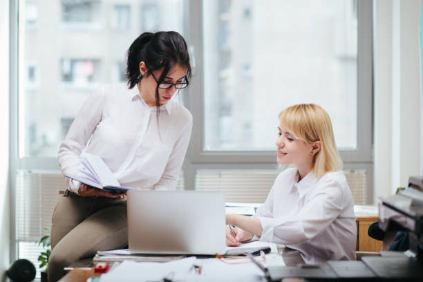 istock Two women working in office 1195877762