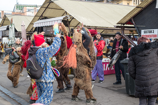 Sibiu, Romania - December 21, 2019. Romanian christmas traditional customs called Bear dancing, on Christmas Eve, in the Cibin vegetable market from Sibiu, Transylvania, Romania