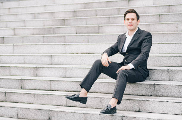 istock Businessman Sitting On Steps In City 1195881818