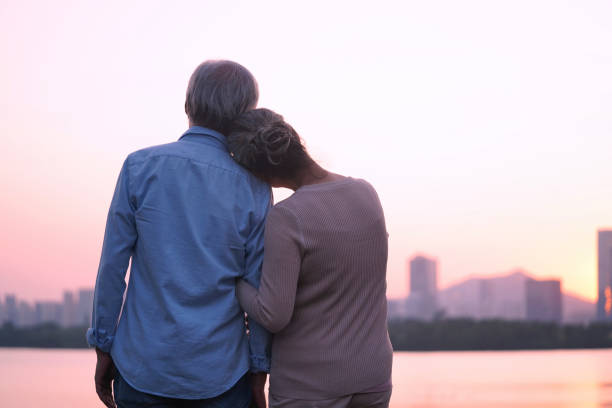 loving senior asian couple watching sunrise