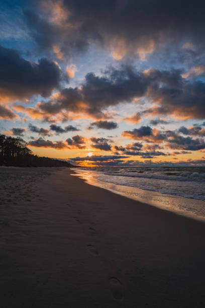 istock Sun sunset on autumn beach dramatic sky on background 1195886760
