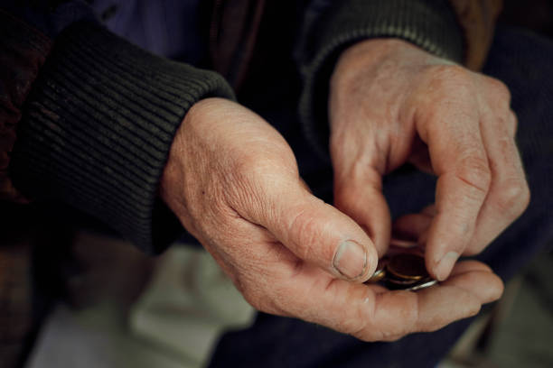 Old hands close up consider coins. Concept of poverty. Old hands count pennies. The concept of poverty, wage arrears.Concept Sanction poverty in Russia. begging currency beggar poverty stock pictures, royalty-free photos & images