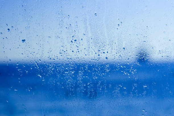 istock Blue window glass with drops and blurs 1195890338