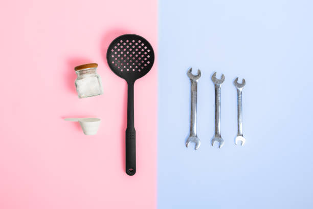 Gender stereotypes: division of men and women specific tasks or activities. Kitchenware opposed to mechanic repair tools in studio background stereotypical stock pictures, royalty-free photos & images