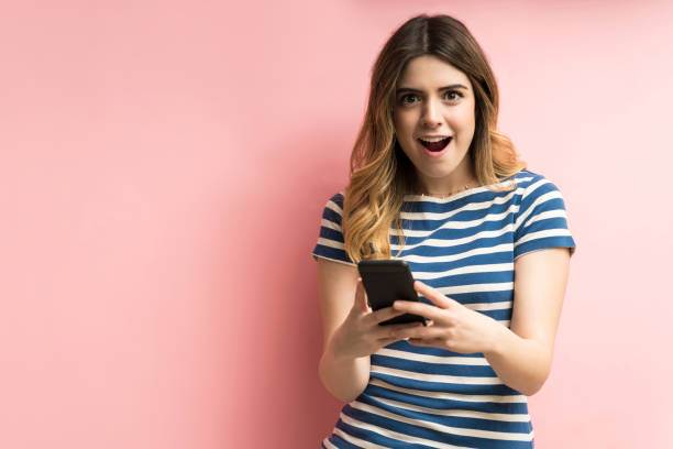 istock Surprised Female With Mobile Phone In Studio 1195891502