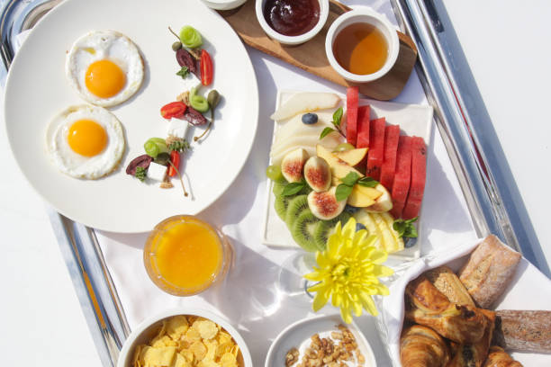 istock Sunny side up eggs, fresh squizeed orange juice, fruit salad and cereals, healthy organic breakfast option 1195892041