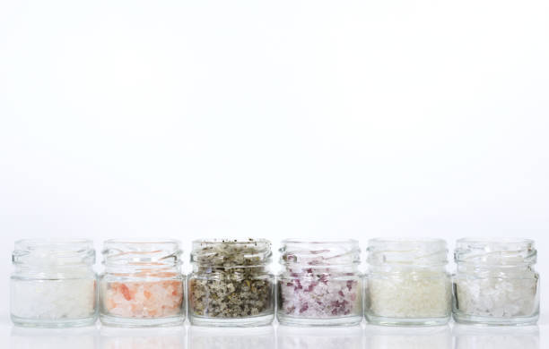 istock Several jars filled with different types of salt stand side by side against a white background with space for text 1195893078