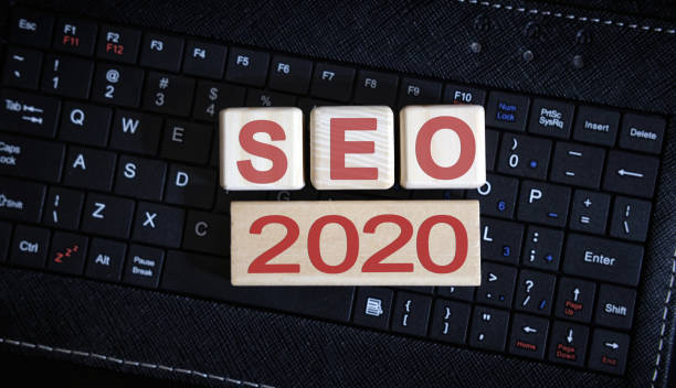 istock Seo 2020 concept. Wooden cubes on a black keyboard 1195893099