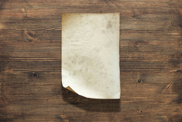 istock paper on wooden background 1195894720