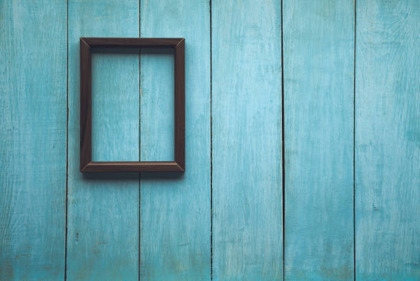 istock photo frame on wooden wall 1195895533