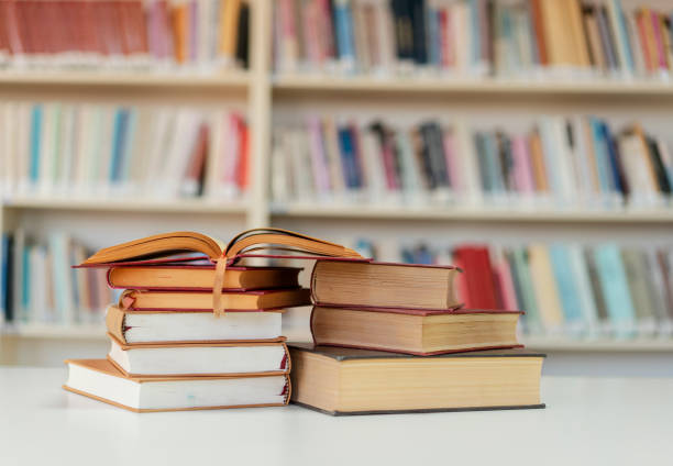 istock Books on the desk in a library 1195897510