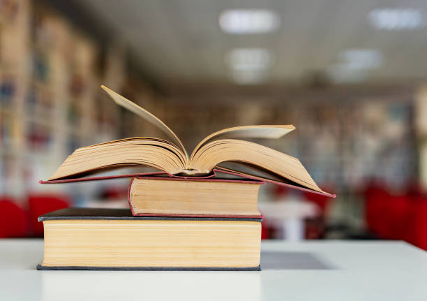 istock Books on the desk in a library 1195899452