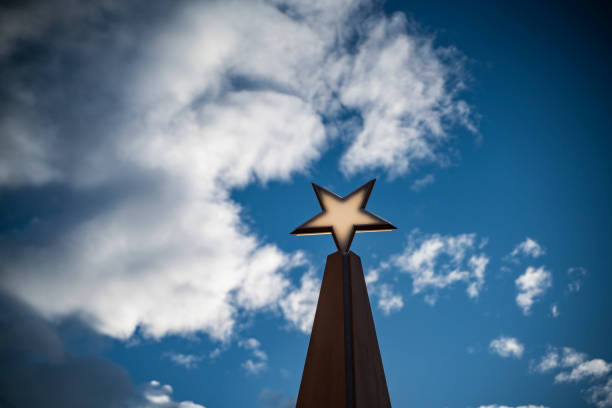 istock cloudy blue sky and decorative star shape from wood 1195902805