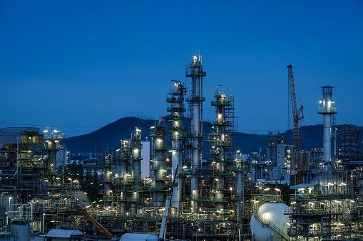 Oil and gas refinery plant or Petrochemical industrial plant on blue sky twilight background, Factory of petroleum with dawn sky, Maintenance machine and Turnaround concept