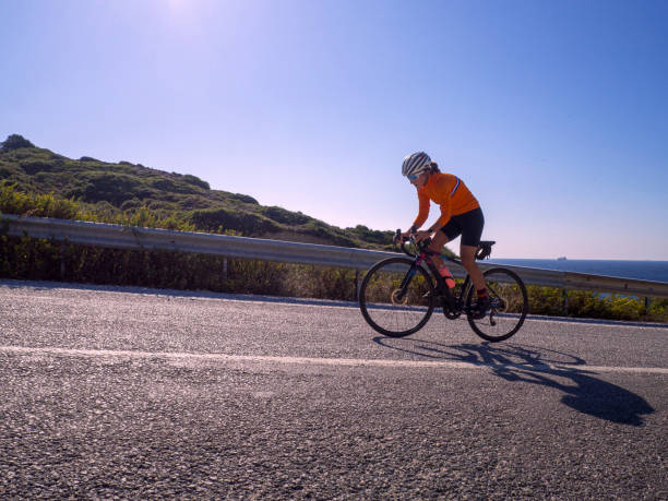 istock woman cycling road bicycle 1195912014