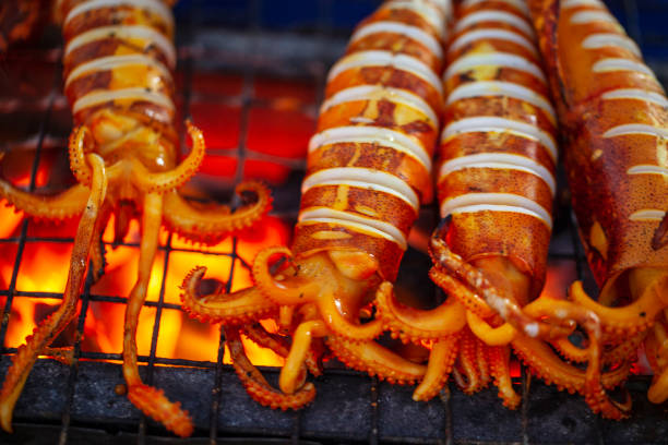 exotic asian food, grilled squid stuffed with seafood exotic asian food, grilled squid stuffed with seafood kep stock pictures, royalty-free photos & images