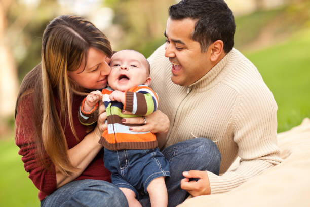 istock Two mixed race parents playing with their baby son 119591247