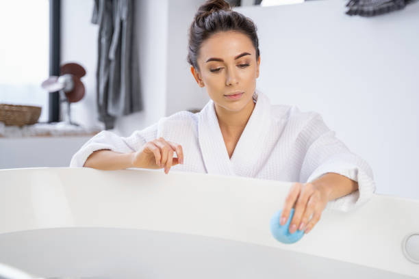 Young woman gazing at a bath ball