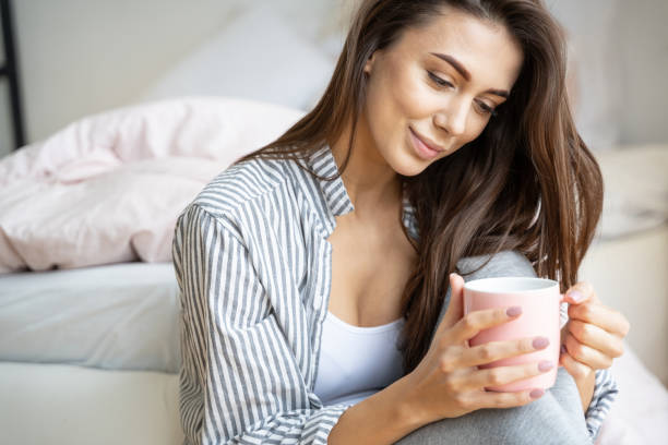 istock Beautiful young lady enjoying her morning coffee 1195914463