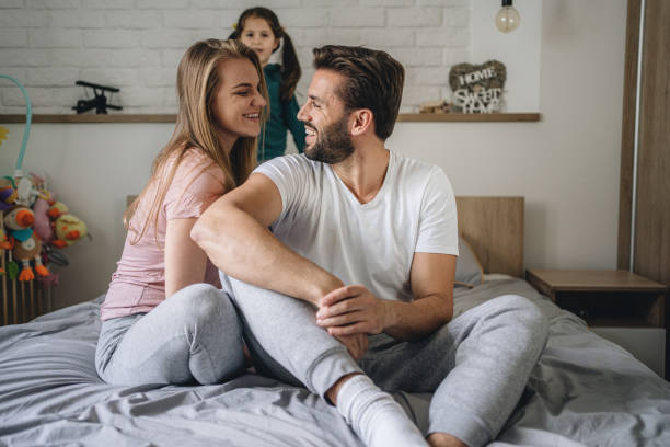 istock Young parents and their daughter spending time at home 1195916599