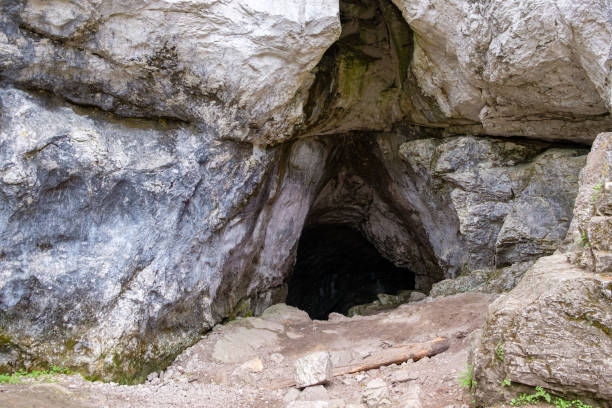 istock cave in the rock among the boulders darkness inside 1195920114