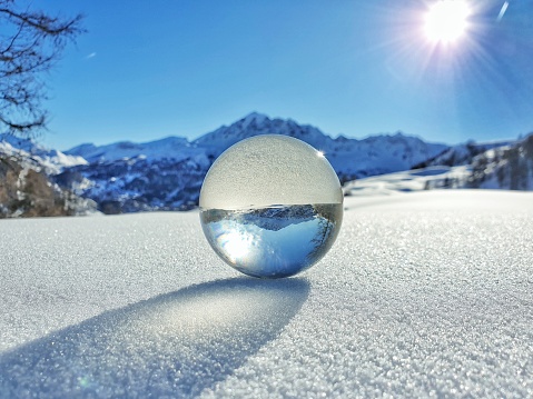 Winter crystal ball, looking through, half snow half mountains, Vars, South Alps, France