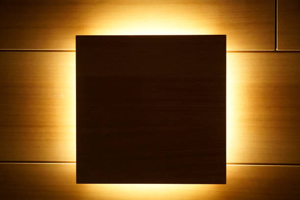 istock Wooden wall as a background with a dark back-lighted square in the centre 1195921665