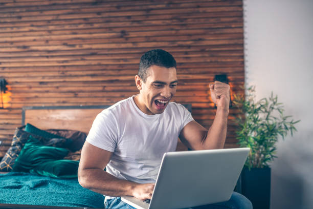 istock Young dark-haired man in jeans feeling happy 1195922548