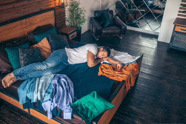 istock Dark-haired young man in white tshirt having a nap 1195922593