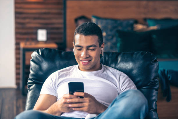 istock Young guy resting at home in an armchair. 1195922610