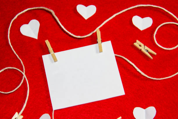 istock A red background from felt. A composition from heart, thread and clothespins. Background with place for write for valentines day and christmas. 1195922662