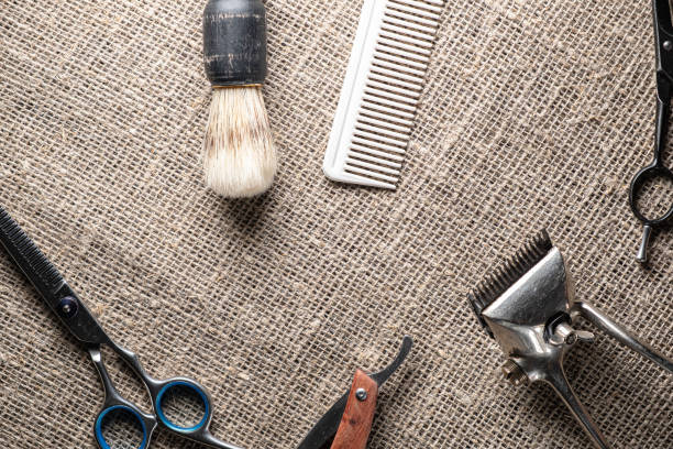 istock vintage barber tools dangerous razor hairdressing scissors old manual clipper comb shaving brush. on sackcloth background. 1195929041