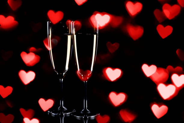 istock Champagne glasses with bokeh heart lights 1195931906