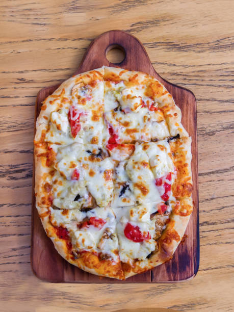 istock Pizza with tomatoes, mushrooms and mozzarella, oval 1195936721