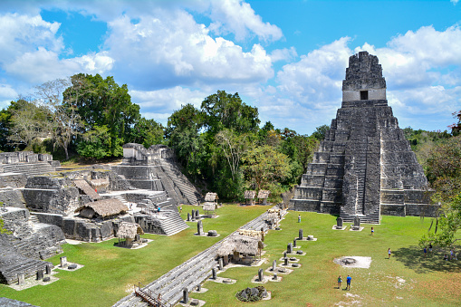 Tikal Ruins, Guatemala 03/11/2015: Overview of the Gran Plaza in the Tikal ruins archaeological national park. Imposing pyramids watch over a large plaza area.