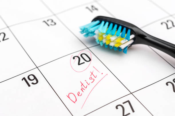 Toothbrush on calendar. Time to visit dentist. stock photo