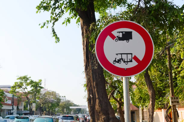 No rickshaws forbidden road sign No rickshaws forbidden road sign. Motor rickshaw, tuk tuk and three wheeler prohibited sign on the street. Phnom Penh, Cambodia. no rickshaws sign stock pictures, royalty-free photos & images