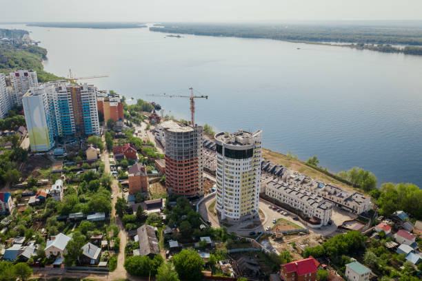 Aerial construction site near river view building in progress