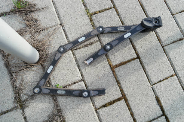 Cut bicycle lock by thieves with bolt cutter after stealing a bike near the parking lot, details, closeup stock photo