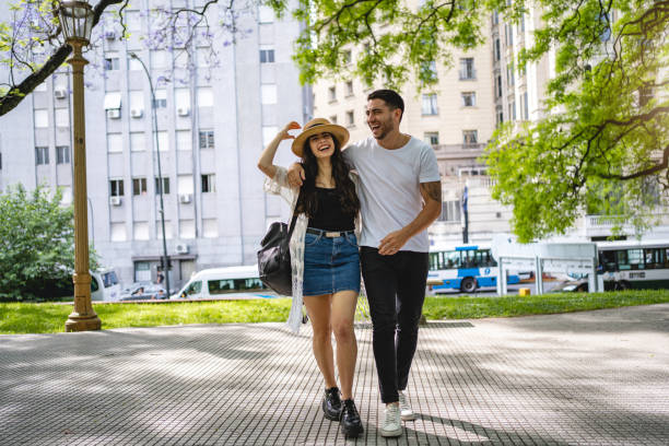 istock Happy young couple walking in a park together 1195943820