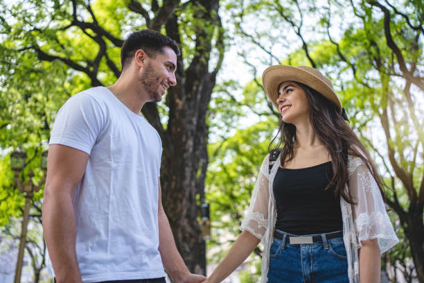 istock Happy young couple bonding in the park 1195943830