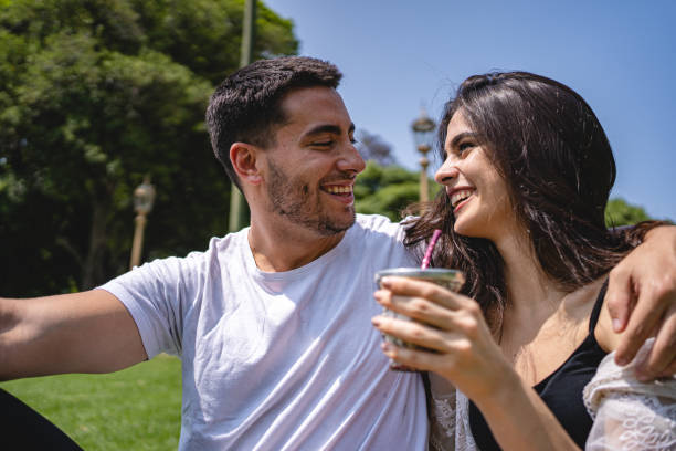 istock Summer couple in love relaxing on grass 1195943866